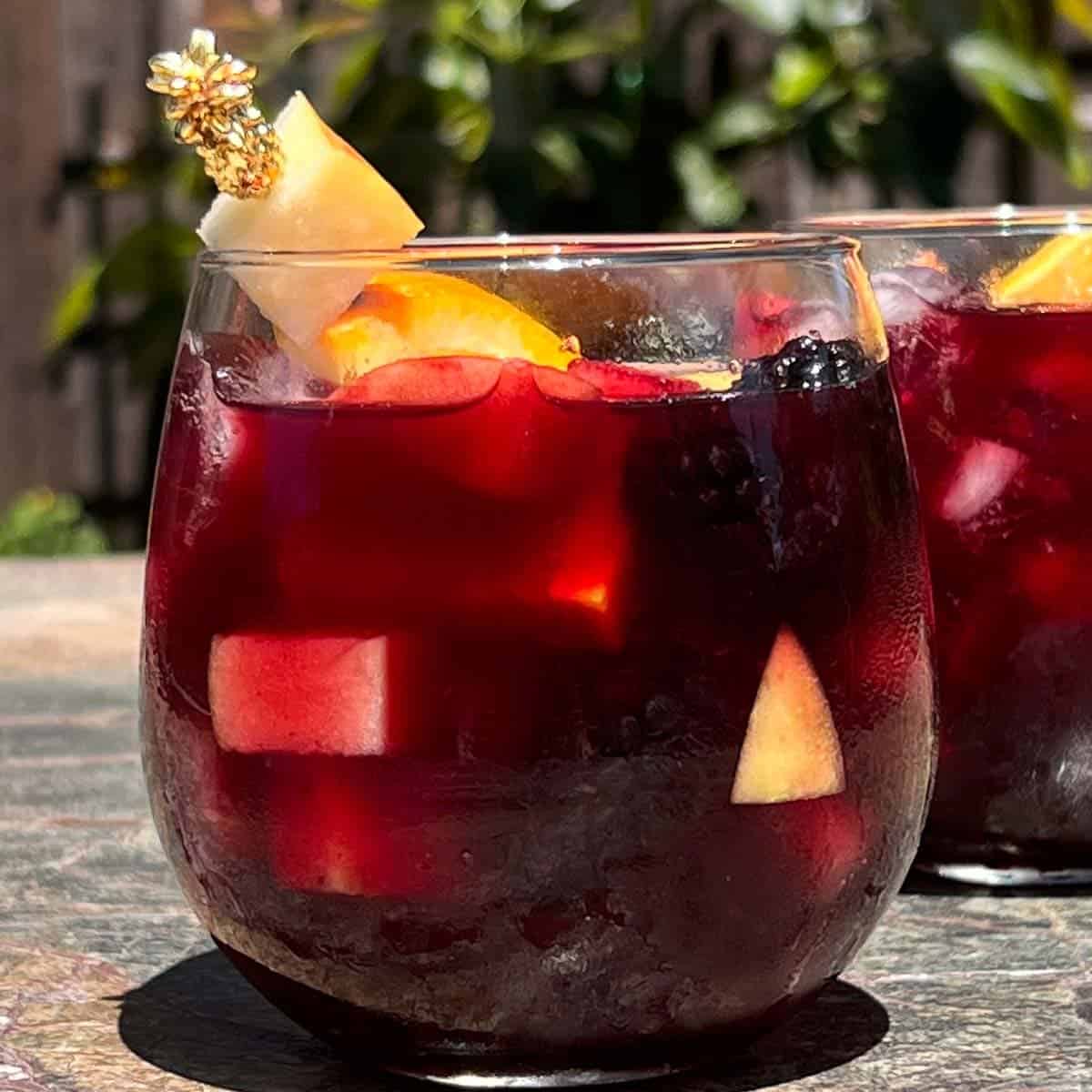 glass of icy cold red wine sangria in the garden