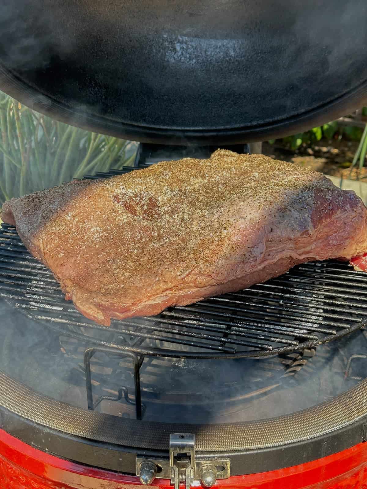 seasoned brisket on the smoker