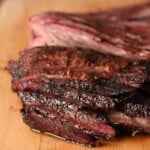 BBQ smoked brisket sliced on a cutting board. showing all of its juicy deliciousness