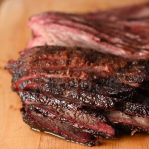 BBQ smoked brisket sliced on a cutting board. showing all of its juicy deliciousness