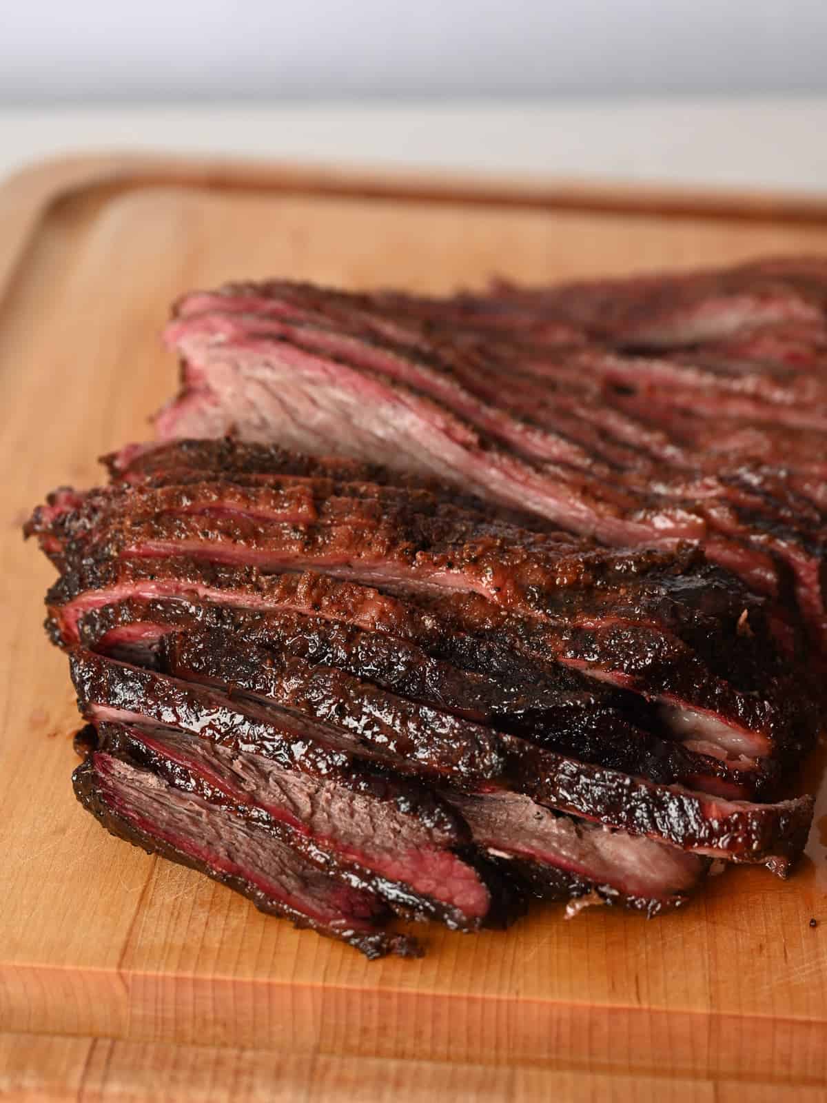 sliced brisket on a boos block