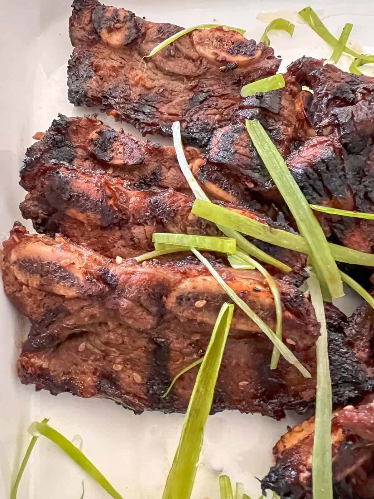 kalbi short ribs garnished with green onions