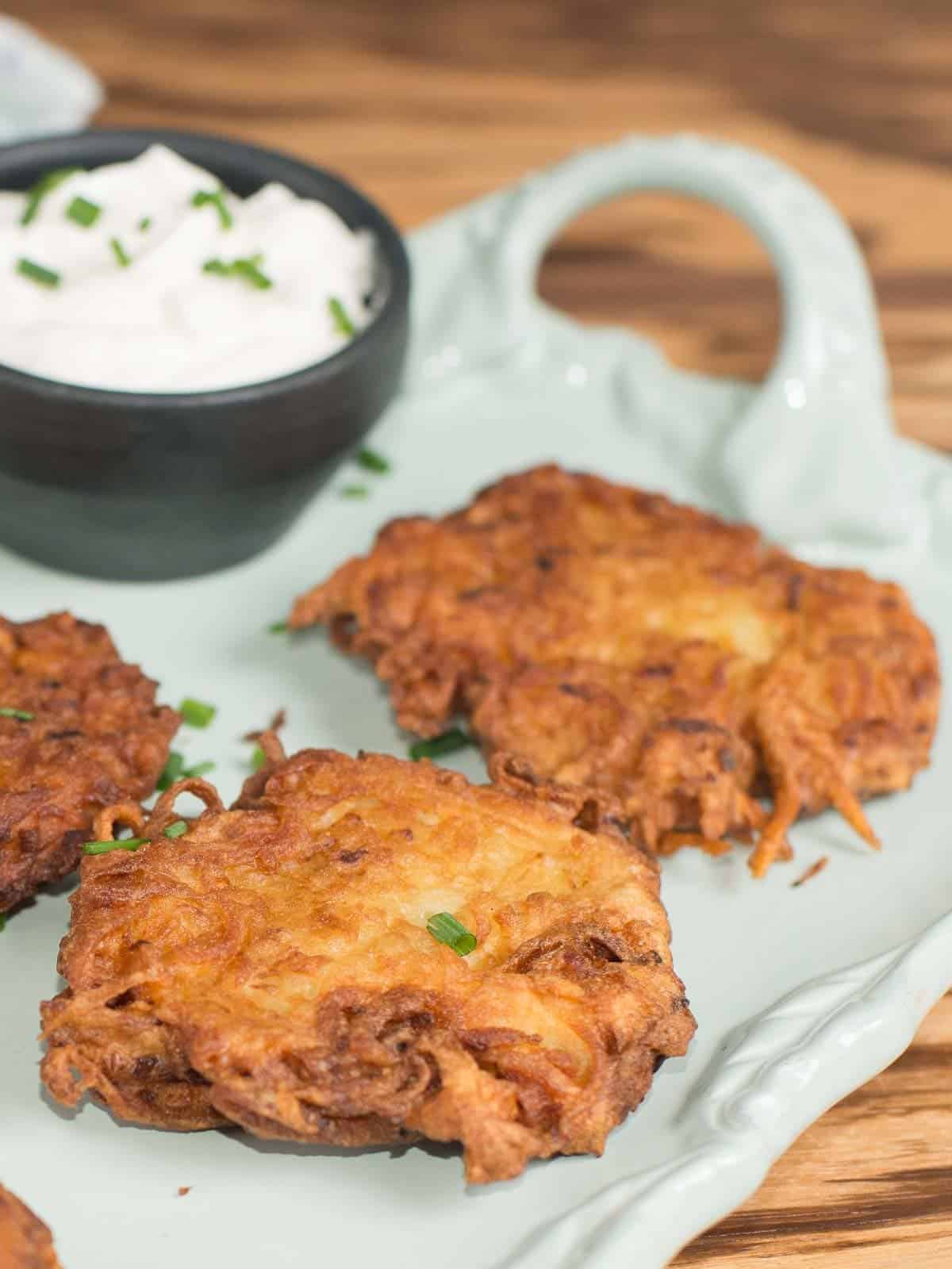 crispy potato latkes served with sour cream and chives