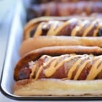 bacon wrapped hot dogs with spicy mayonnaise drizzle