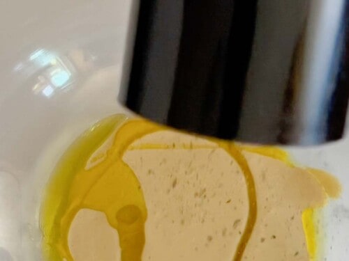 add a llittl it of olive oil and black pepper to the emulsified caesar dressing.