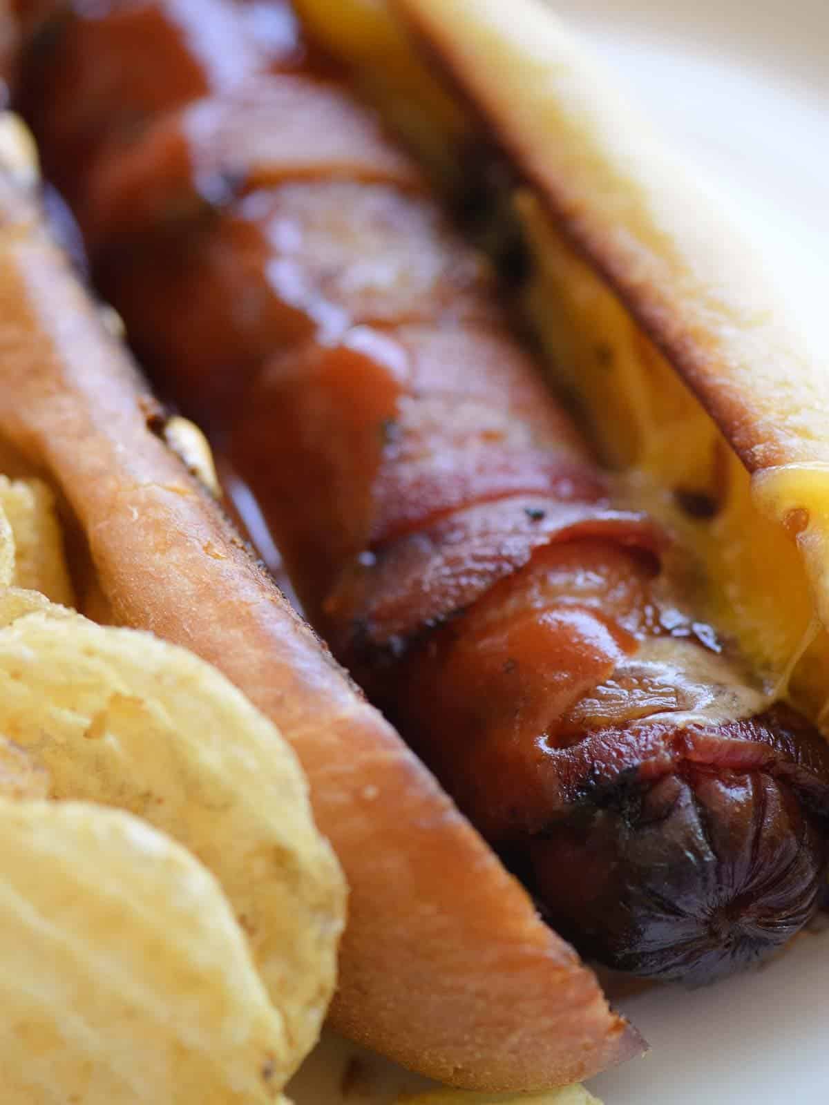 bacon wrapped hot dogs with cheese and bbq sauce