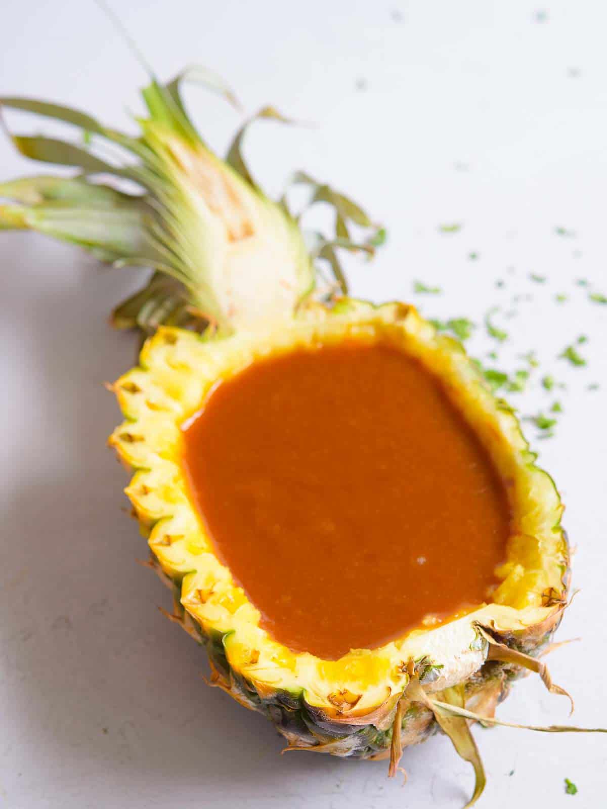 huli huli sauce in a a pineapple bowl