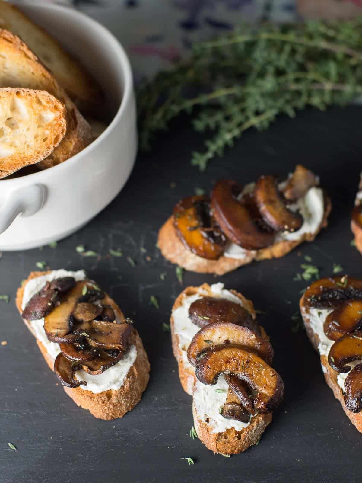 easy crostini recipe slathered with goat cheese and topped with sauted mushrooms