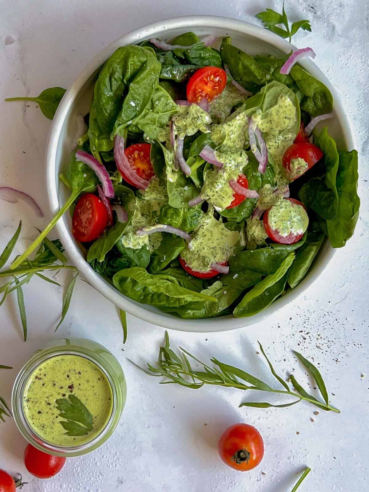 salad with green goddess dressing on a white bowl