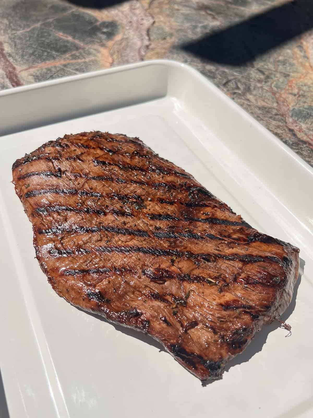 grilled steak resting on a platter