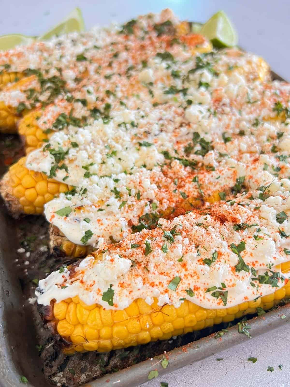 corn on the cob with mexican crema dressing, cotija cheese and hot sauce