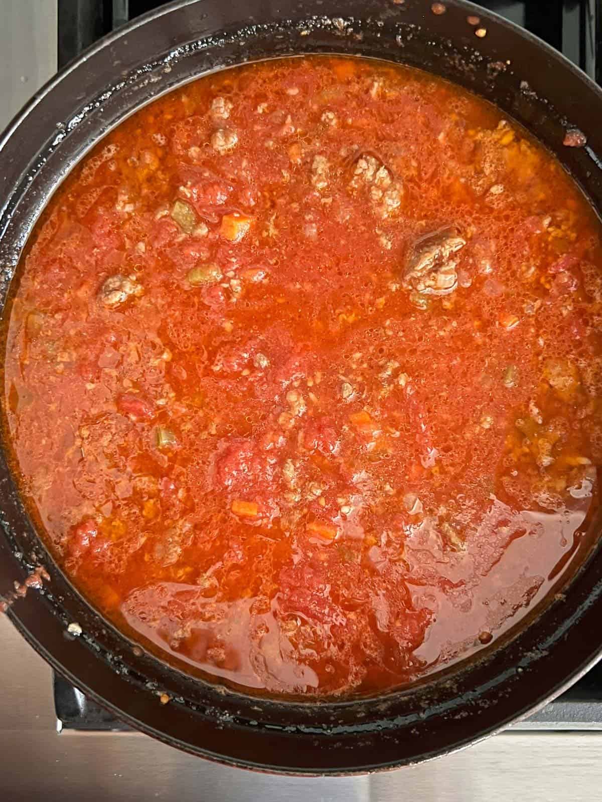 add the crushed tomatoes to the pot