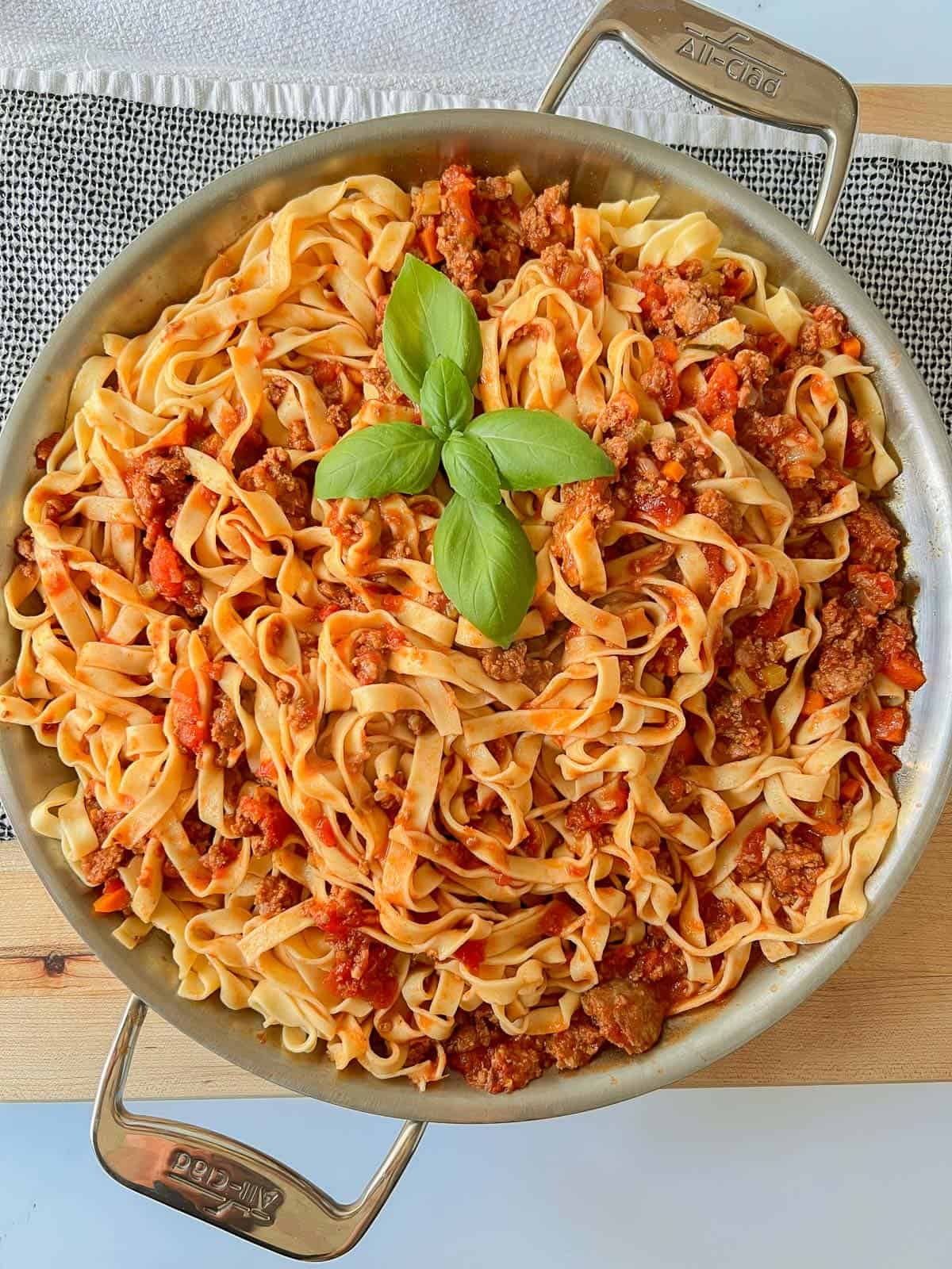 A pan of homemade pasta with bolognese sauce. 