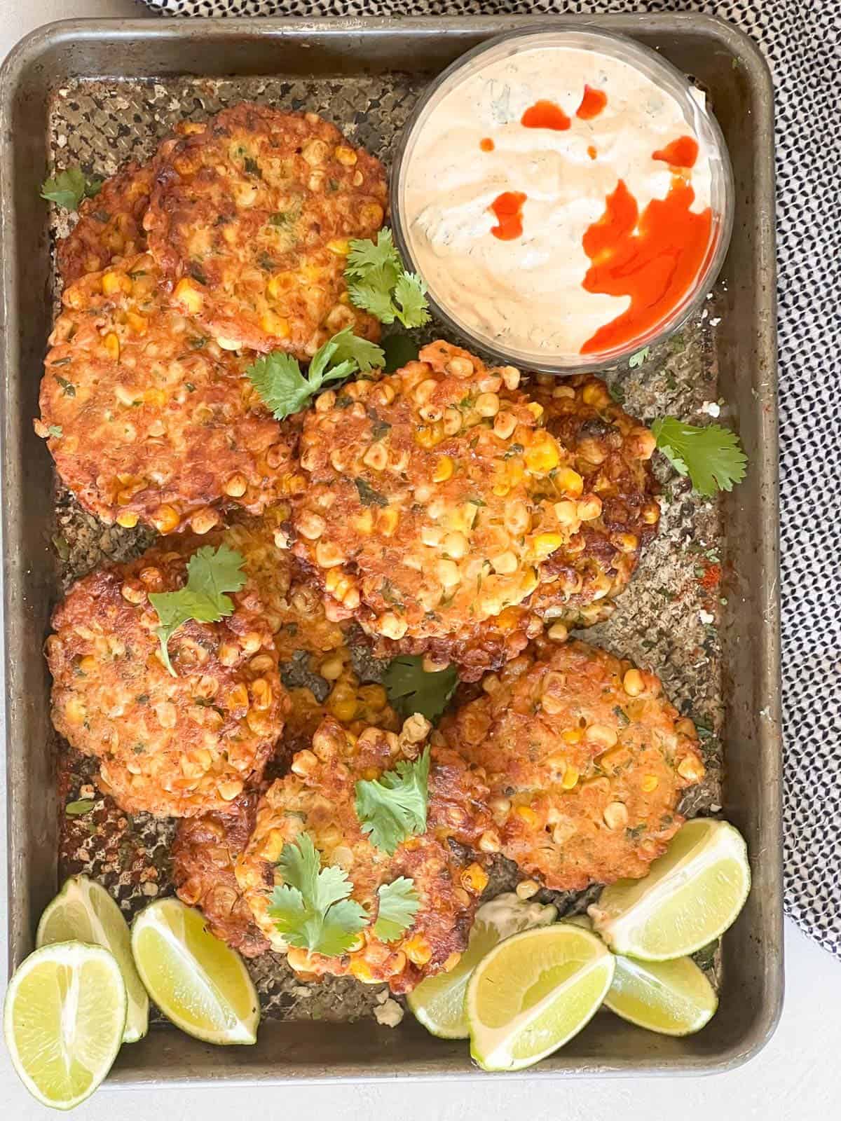 corn fritters on a baking sheet