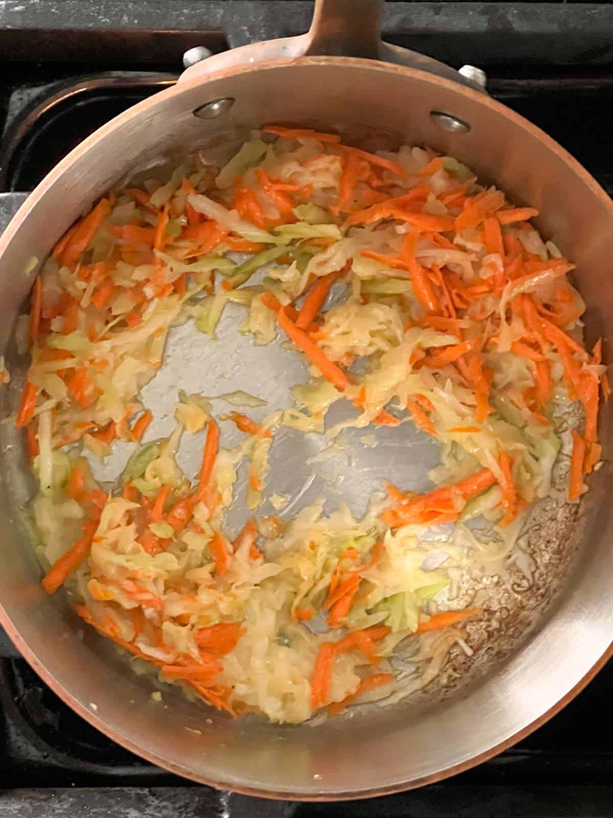 carrots and celery and savory sweetness to homemade bbq sauce cooking in a pan