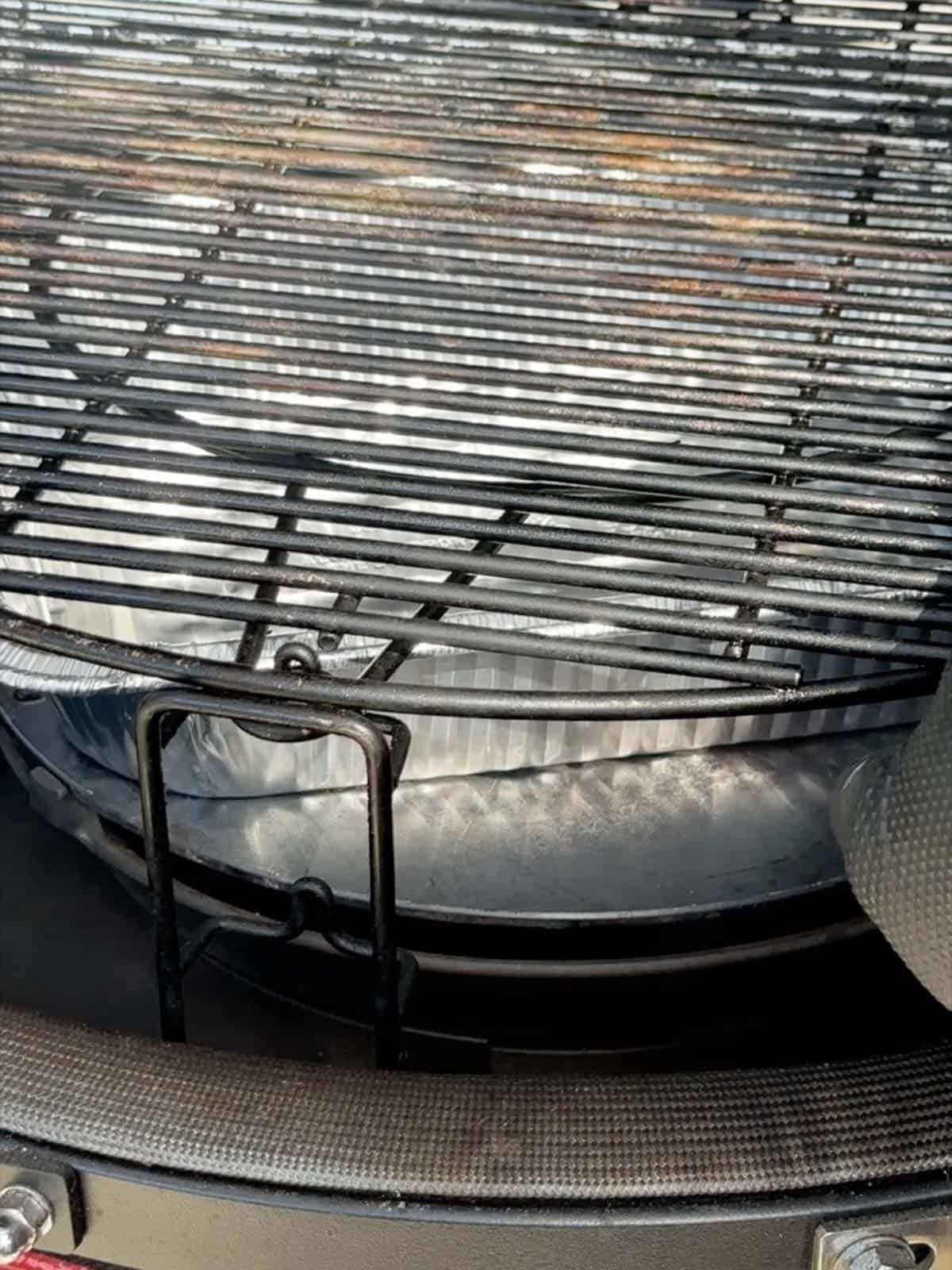 set up the grill grates with a drip pan underneath