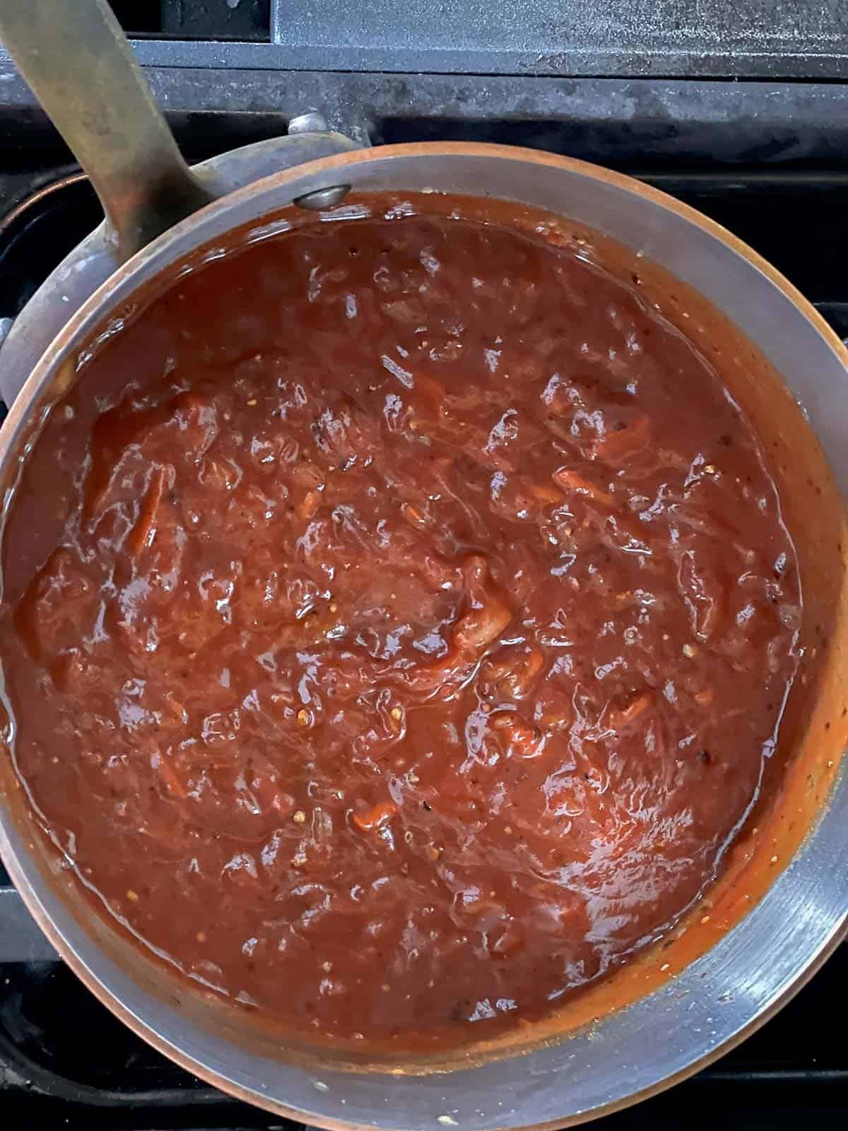 bbq sauce simmering in a pan