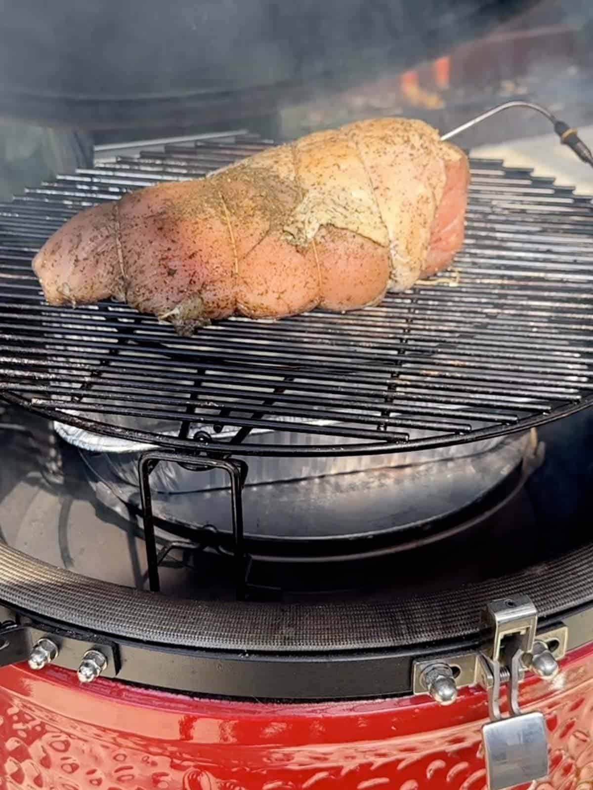 turkey breast added to the grill with a probe thermometer, ready to smoke