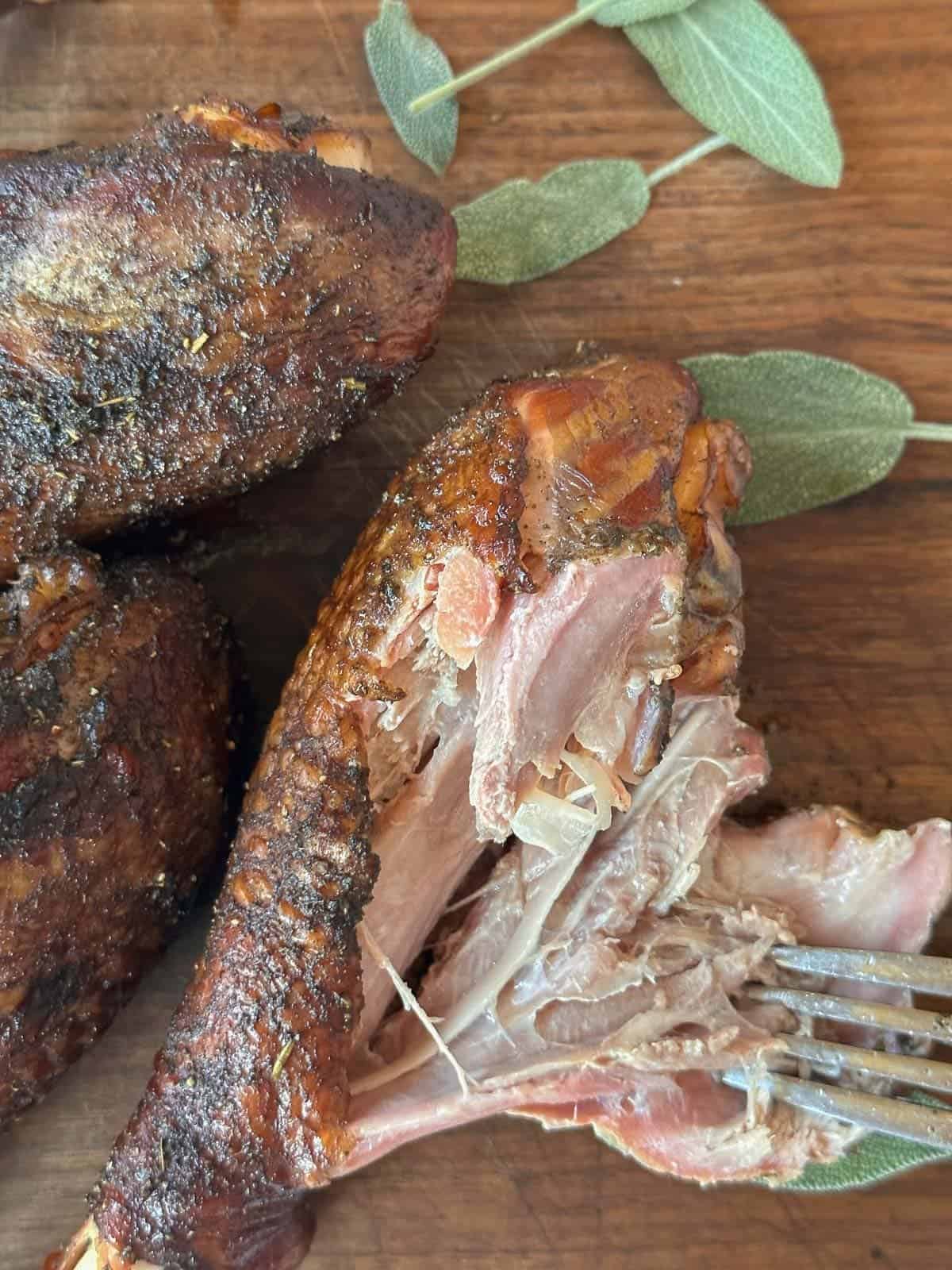 inside of smoked turkey legs showing tenderness