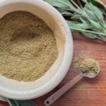 poutlry seasoning recipes in a mortar with fresh sage next to it.