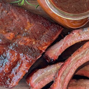 smoked ribs recipe sliced and served with homemade barbecue sauce