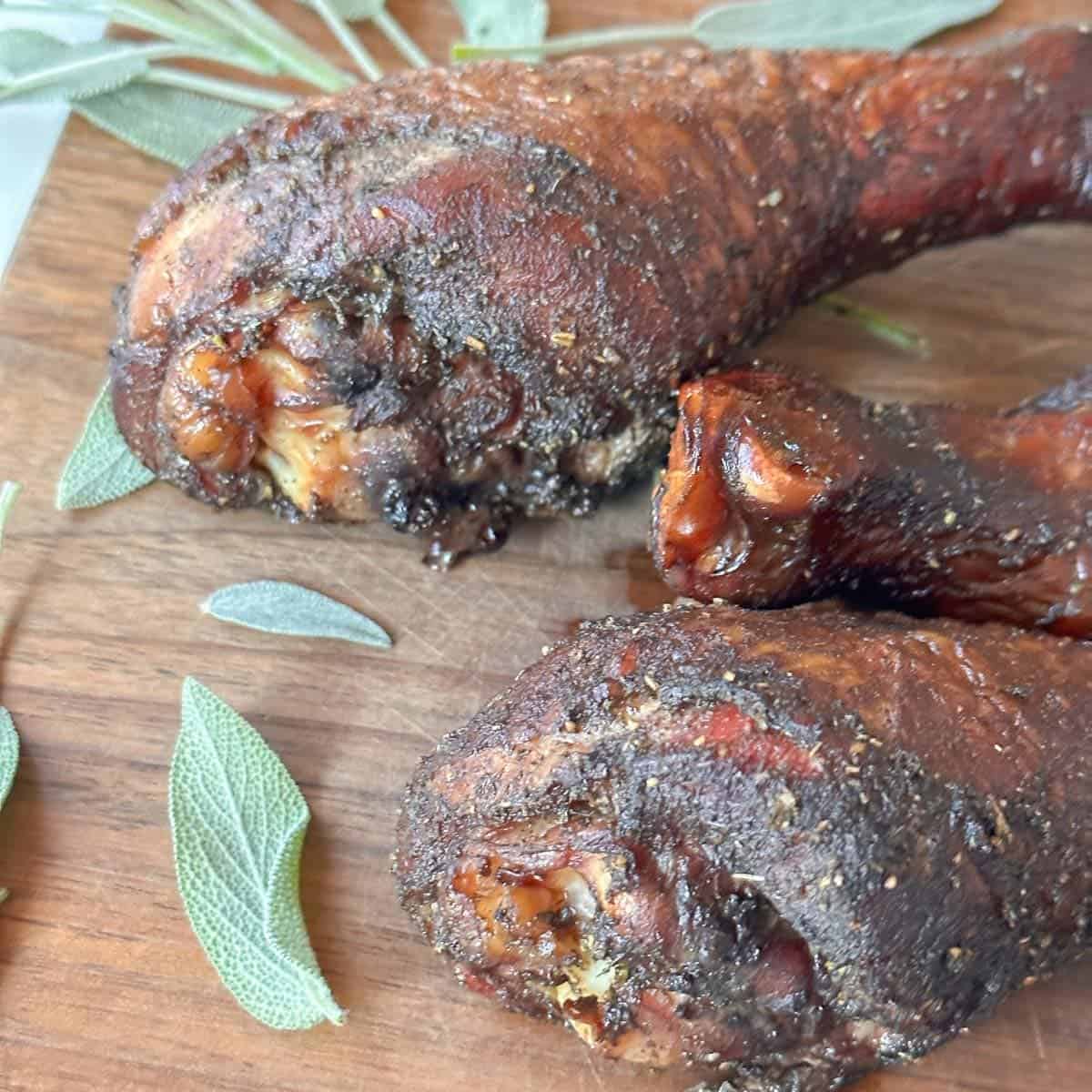 smoked turkey legs on displayed with fresh sage leaves