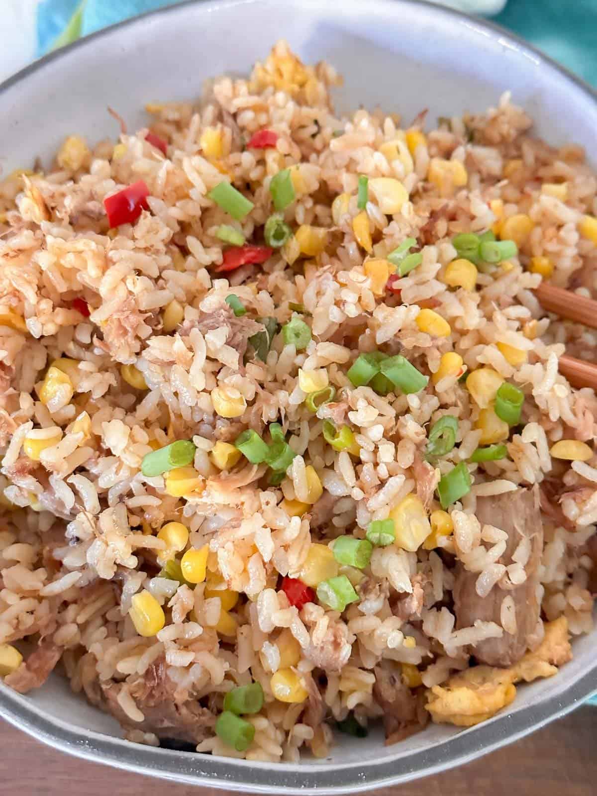 the best hawaiian jpork fried rice close up with lots of green onions and corn