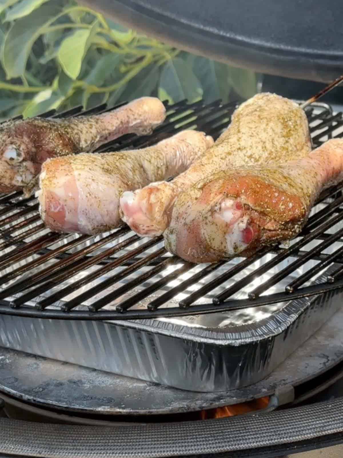 4 turkey legs on the grill of a kamado joe ceramic smoker