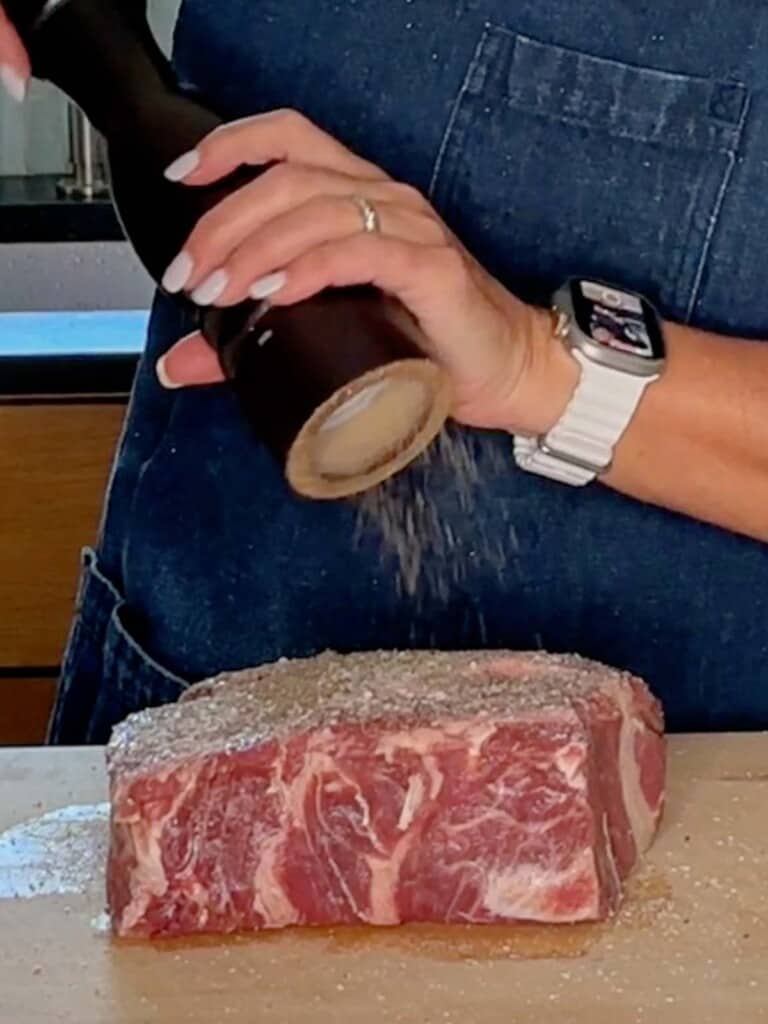 seasoning the chuck roast with salt and pepper
