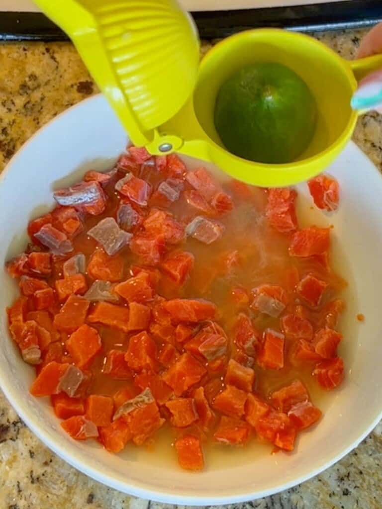 Squeeze in lime juice over the diced salt. Cured salmon for making lomi-lomi salmon