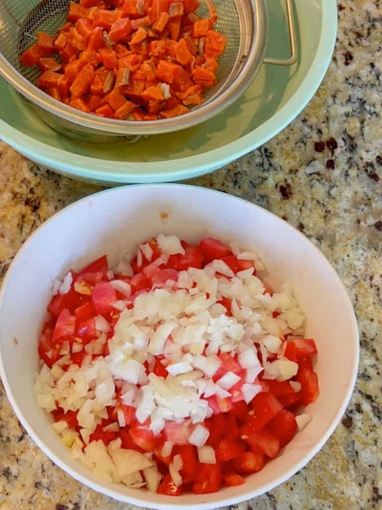 Drain off the lime juice and then add the salted salmon into the bowl that contains tomatoes and diced onions