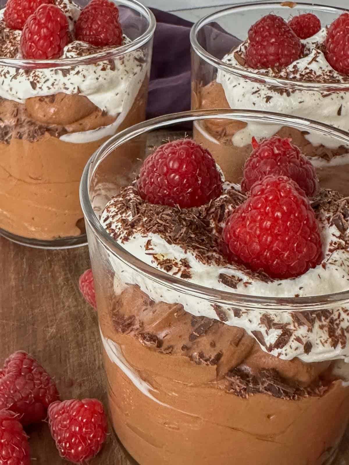 chocolate mousee served with whipped cream, fresh berries, and chocolate shavings