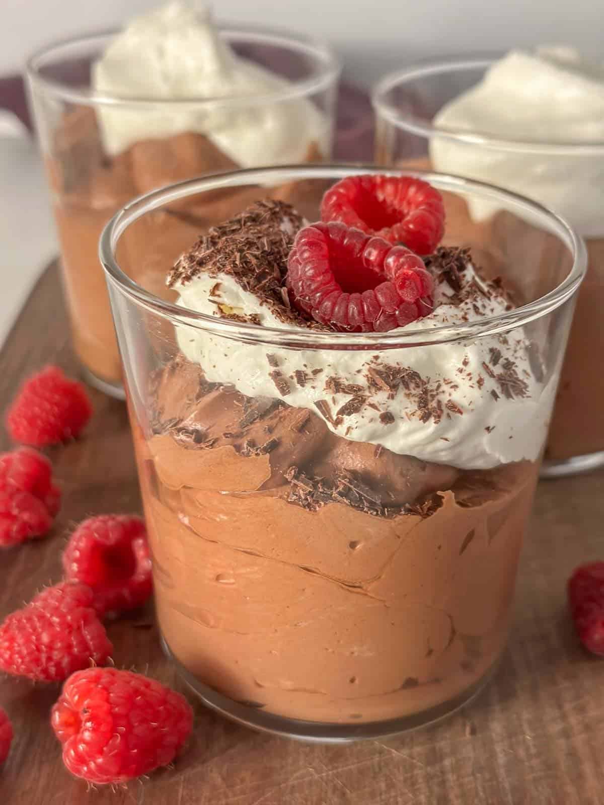 light and airy chocolate mousse topped with whipped cream and raspberries