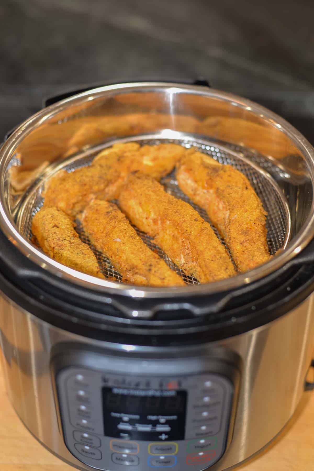 crispy fish fillets in an air fryer basket