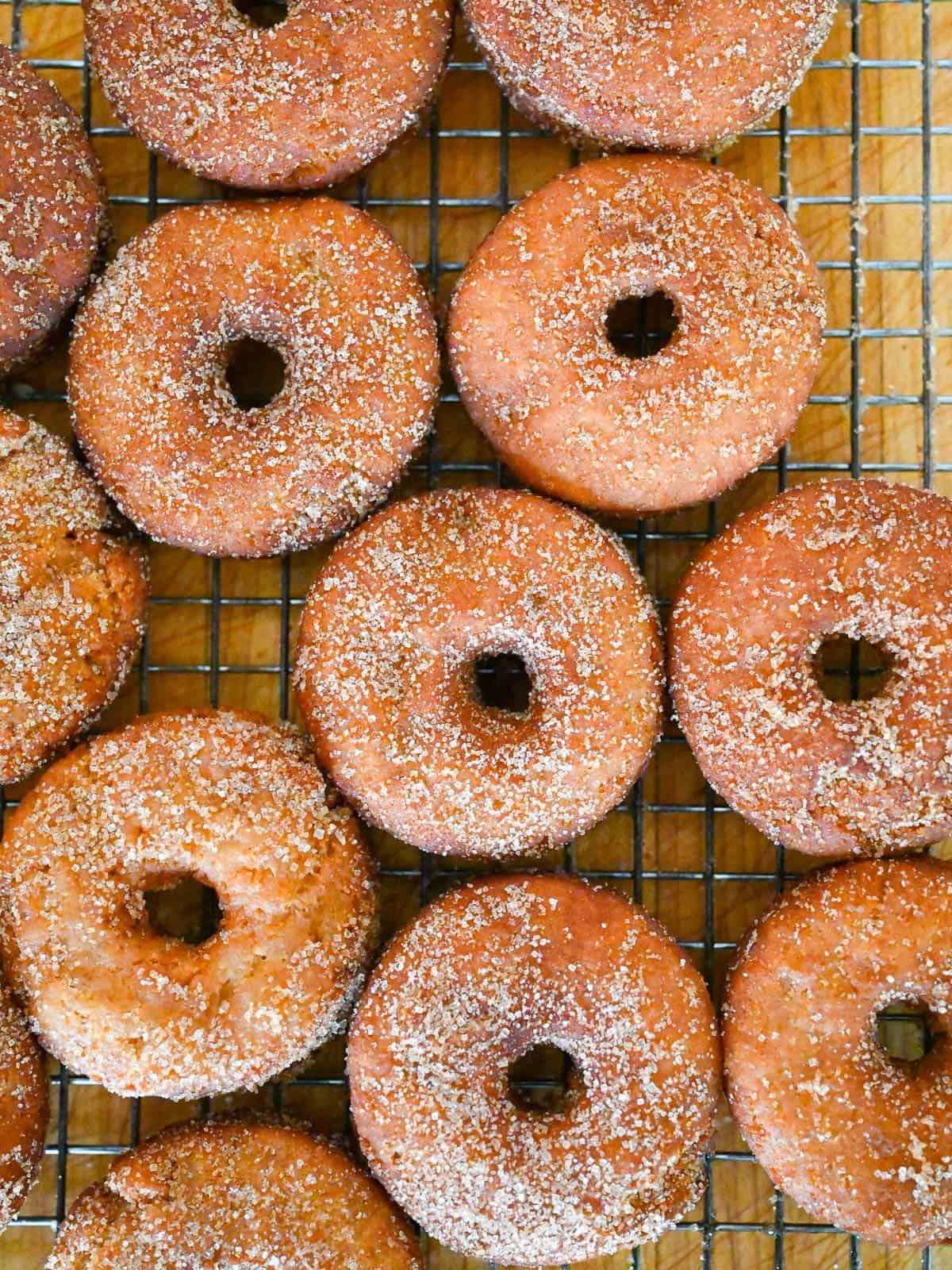 apple cider donuts on a wire rack cooling, waiting for the first bite