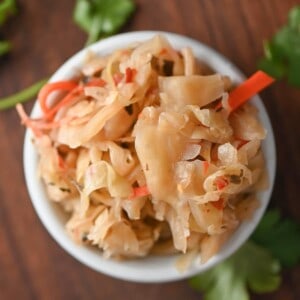 homemade curtido in a small white bowl close up