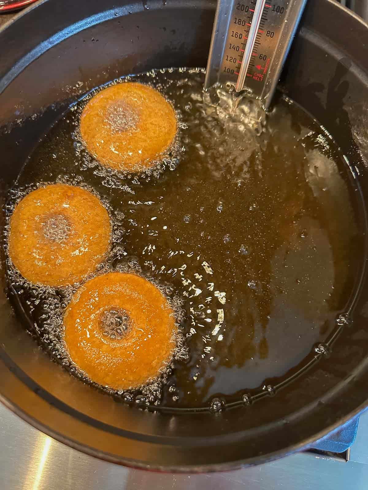 frying donuts in a cast iron dutch oven