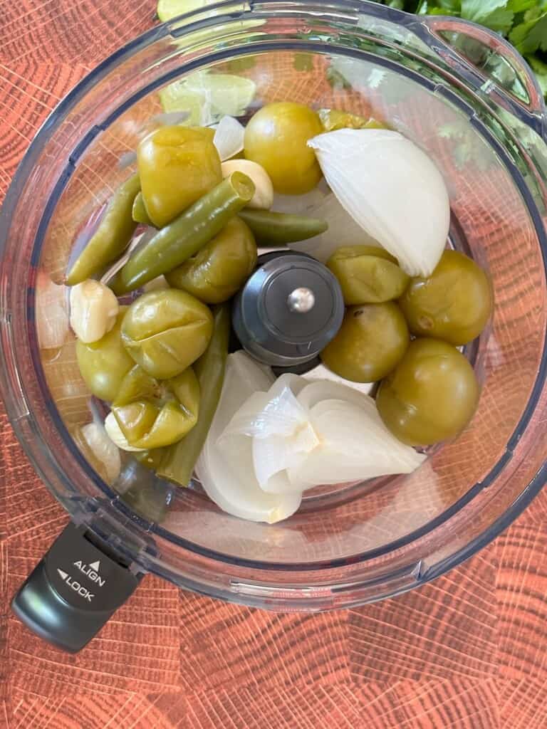 salsa verde ingredients in a food processor before blending