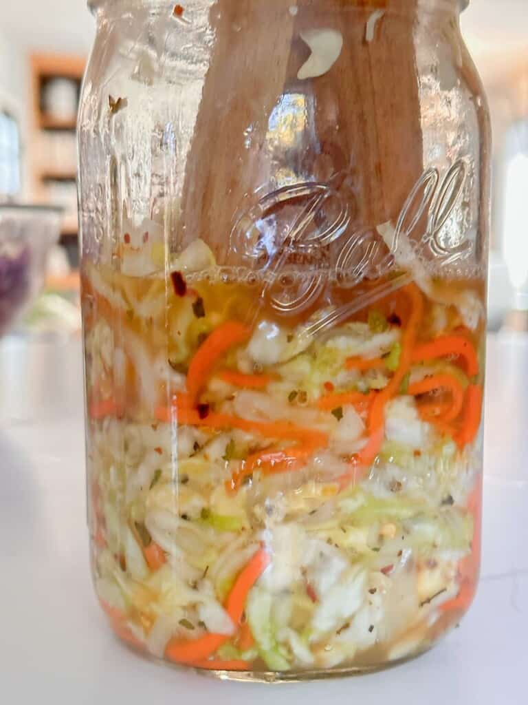 adding the cabbage mixture to sterilized mason jars