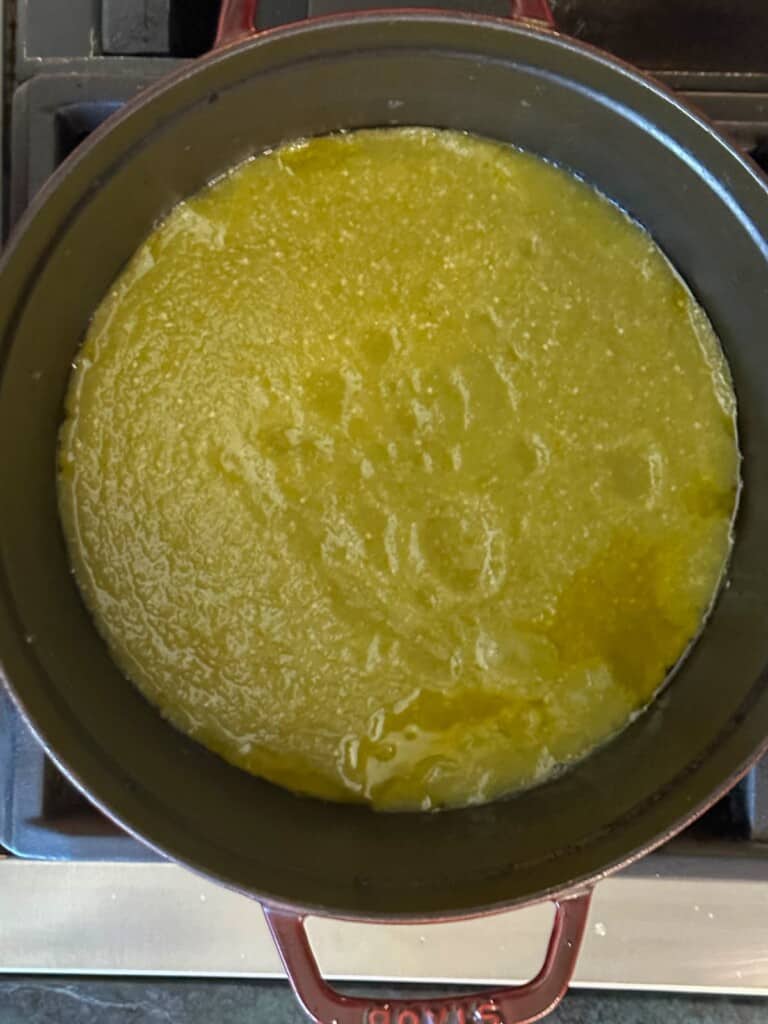 salsa verde cooking in a large cast iron dutch oven