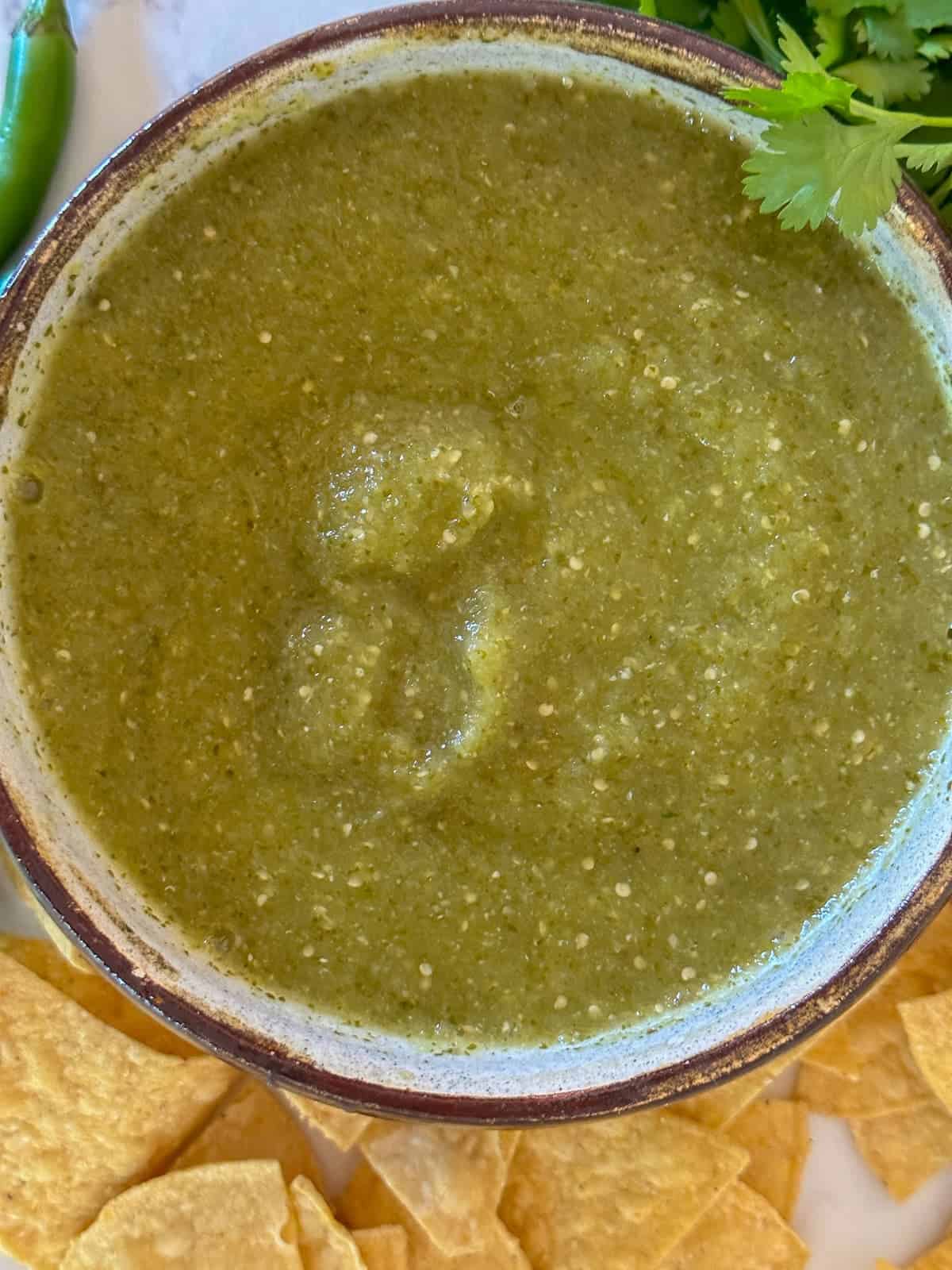 homemade salsa verde in a bowl pictured with tortilla chips