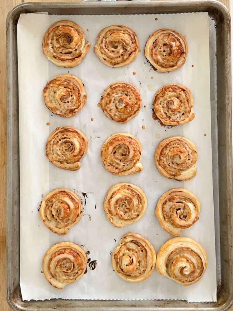 ham and cheese pinwheels on a baking sheet, baked to a rich golden brown