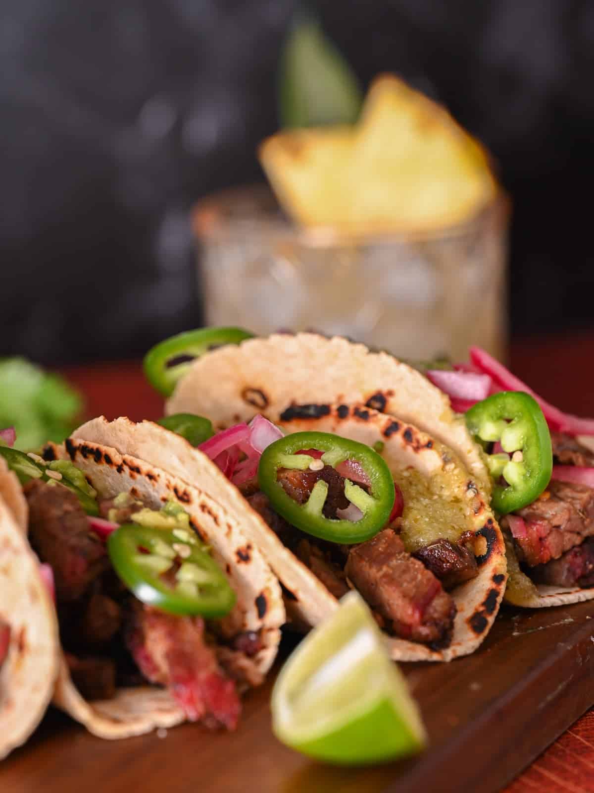 brisket tacos served with a pineapple margarita in the background