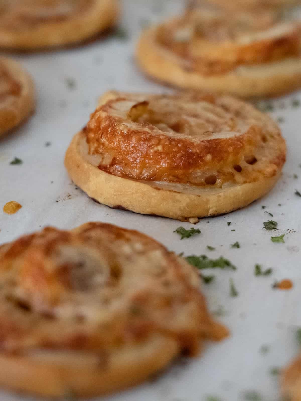 Ham and cheese pinwheels freshly baked. flaky puff pasty dough, mustard, ham and cheese baked to perfection.