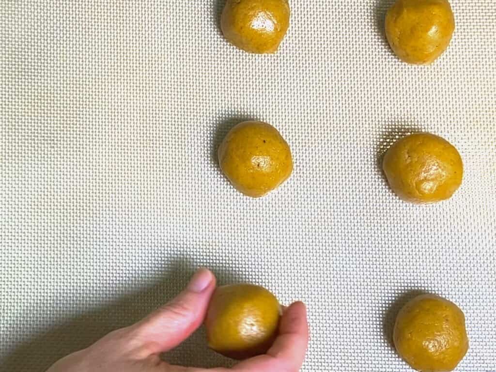 make cookie balls and place them on the baking sheet
