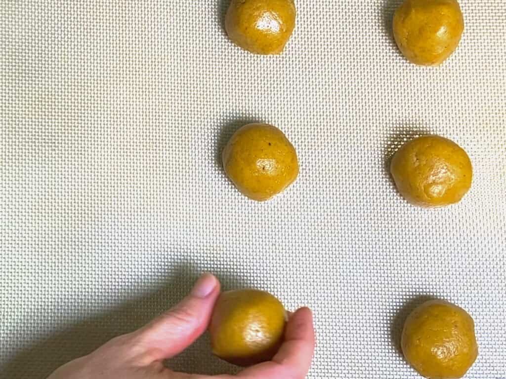 make cookie balls and place them on the baking sheet