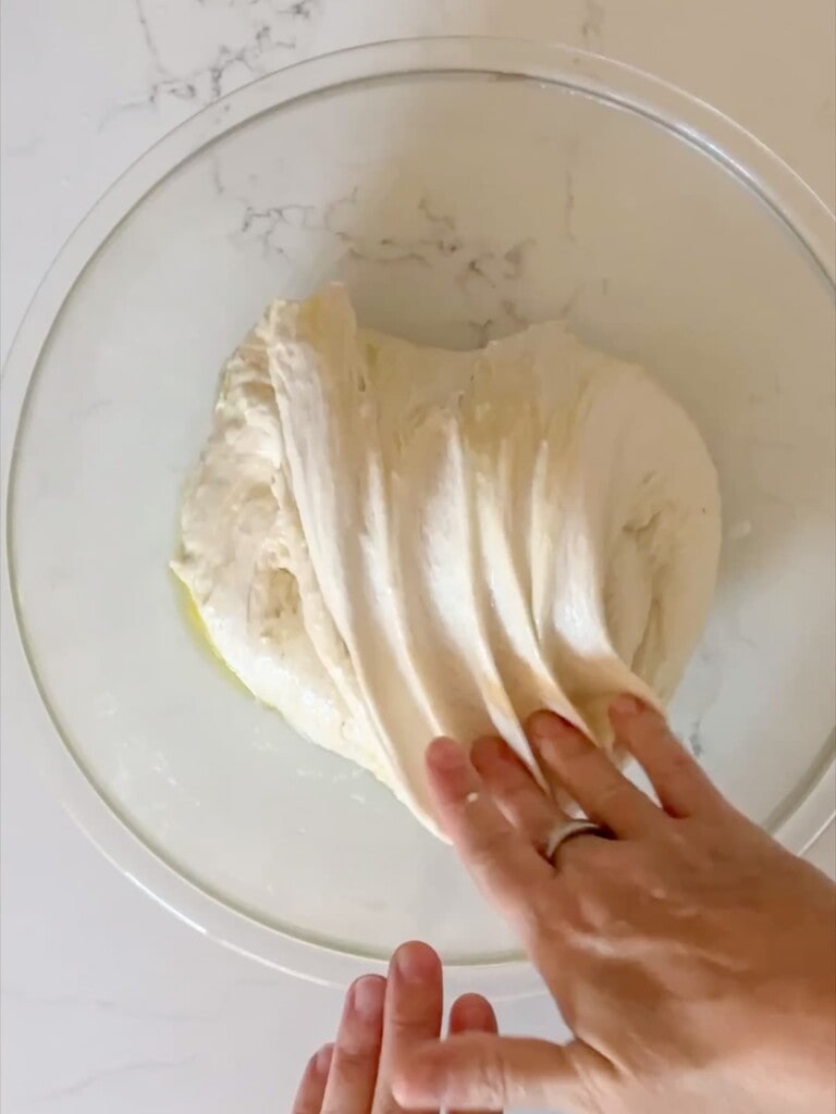 demonstration of the pull and turn method of bread folding, often used with no knead bread recipes