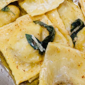 close up of pumpkin ravioli with brown butter sauce