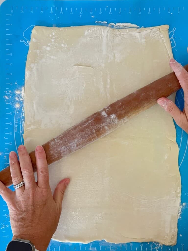 using a rolling pin to roll out the puff pasty dough