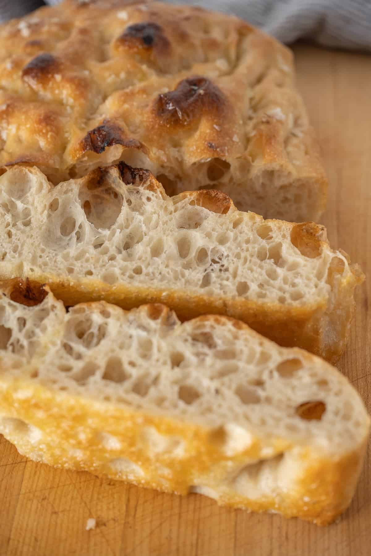 the best homemade focaccia bread sliced and just waiting to be devoured